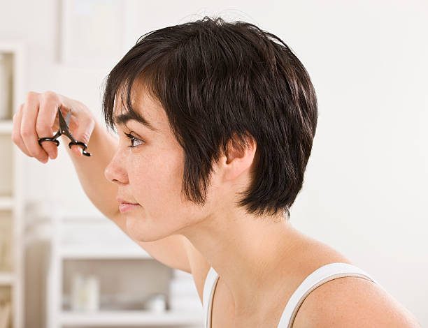 How To Deal With Mtf Sideburns 1 Woman Trimming Bangs Female Sideburns Stock Pictures, Royalty-Free Photos &Amp; Images